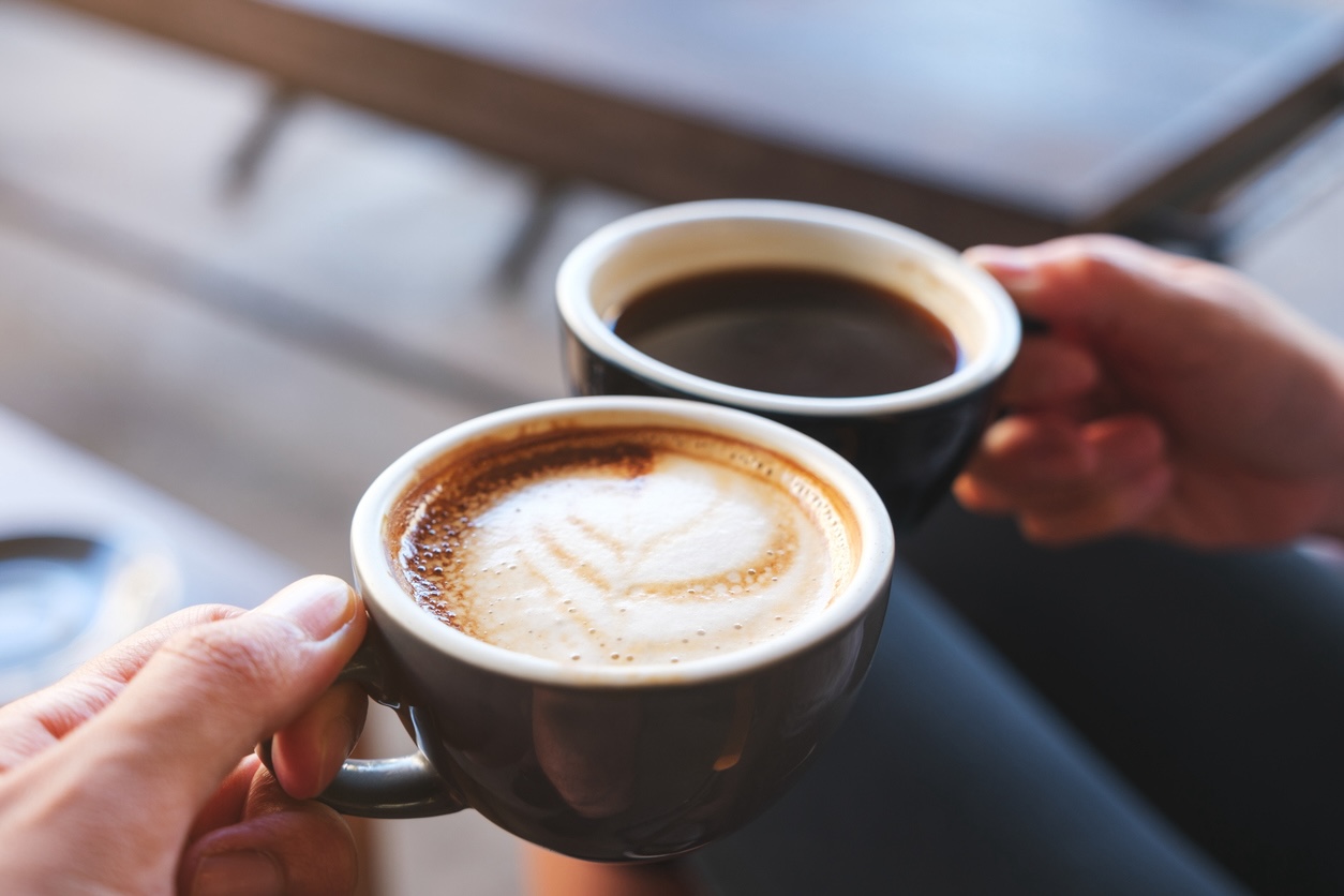 Two people enjoying coffee at a local café near a Mt. Juliet hotel, perfect for travelers visiting Nashville.