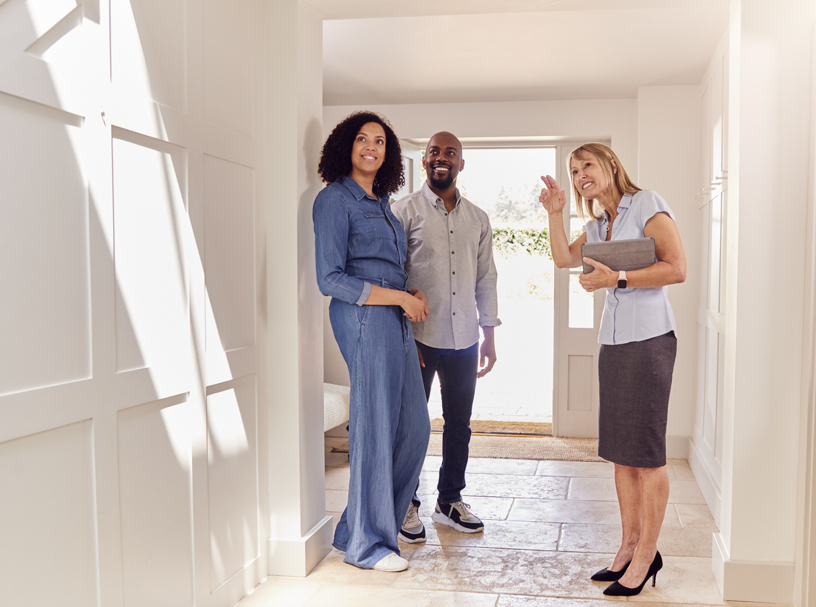 Couple Viewing Potential New Home With Real Estate Agent