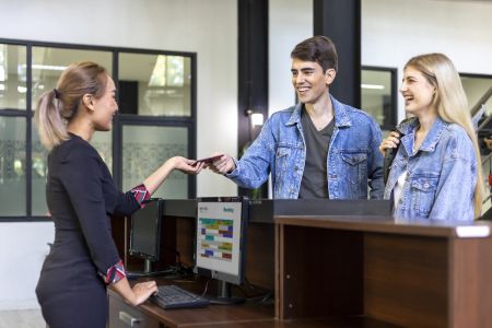 Picture of receptionist and businesswoman at hotel front desk